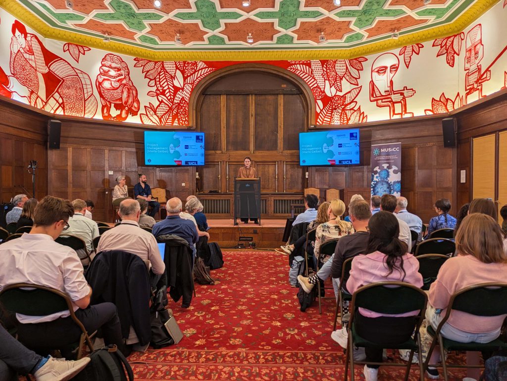A presentation being given to a seated audience at the 2nd MUSICC annual meeting 2025.