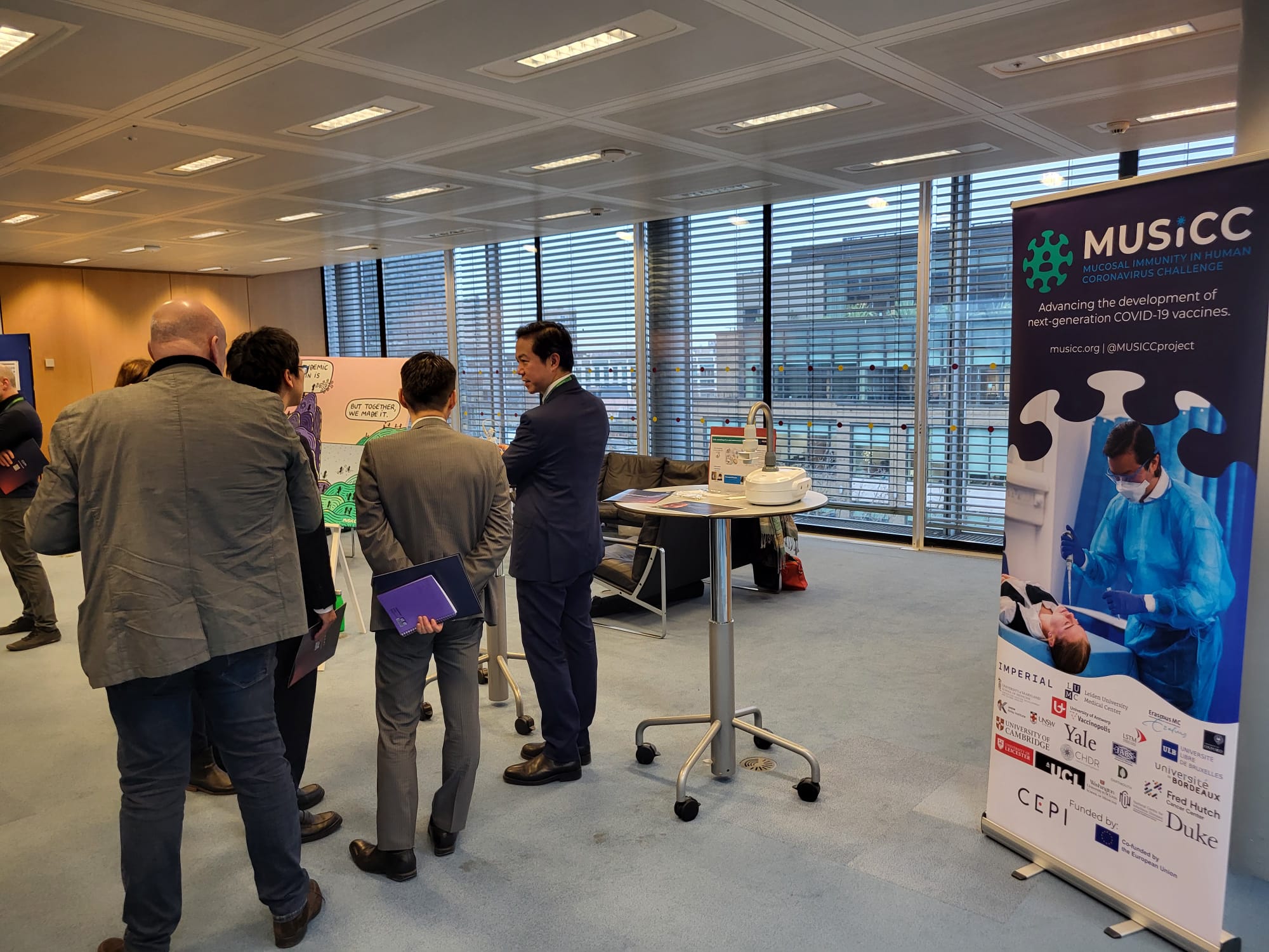 Photo of investors engaging with the MUSICC stand at CEPI's investor event