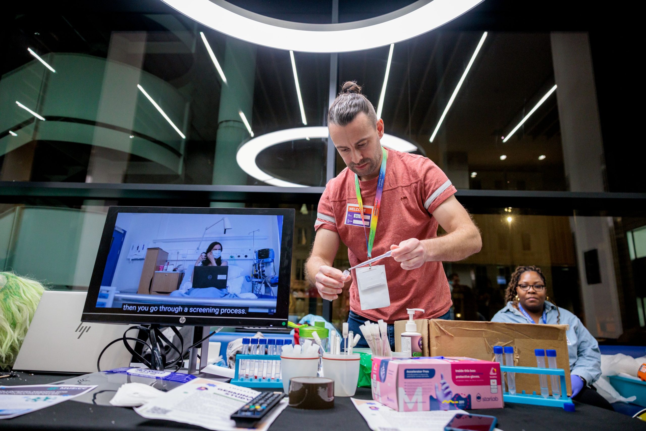 Photograph of MUSICC staff resetting activities at the Would You Get Sick for Science stand.