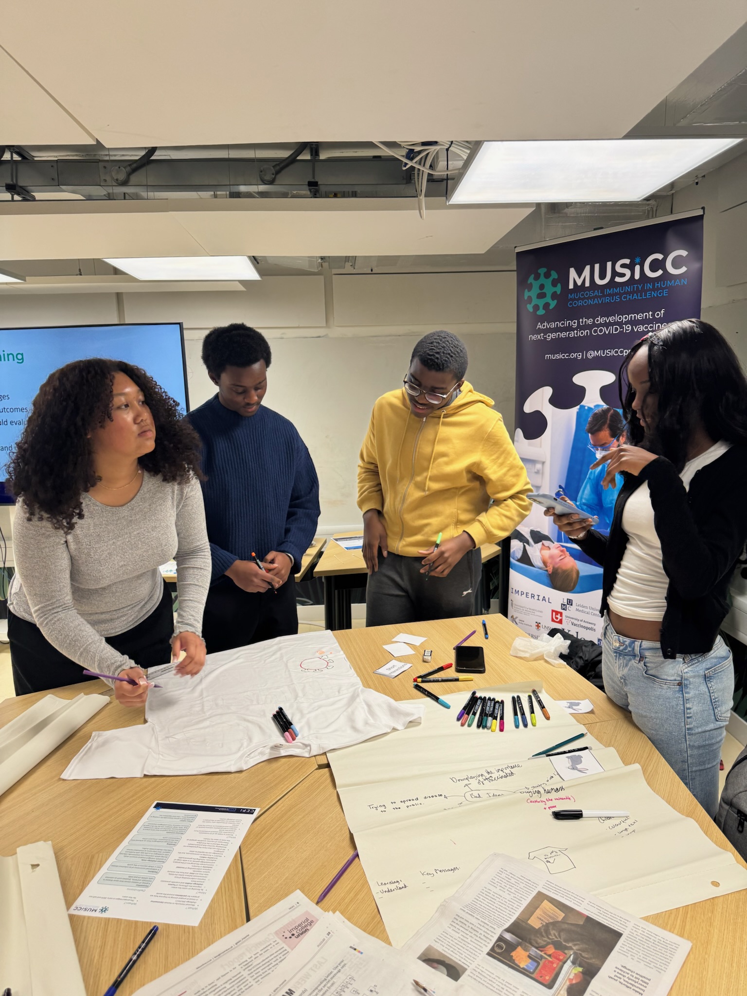 Photograph of Year 12 students working together on their t-shirt design.
