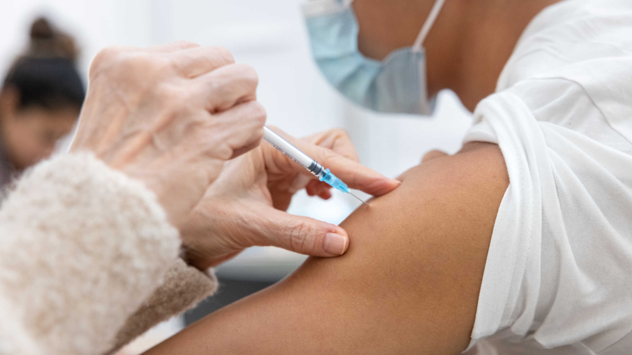 Photograph of a vaccine being injected into a person's arm.